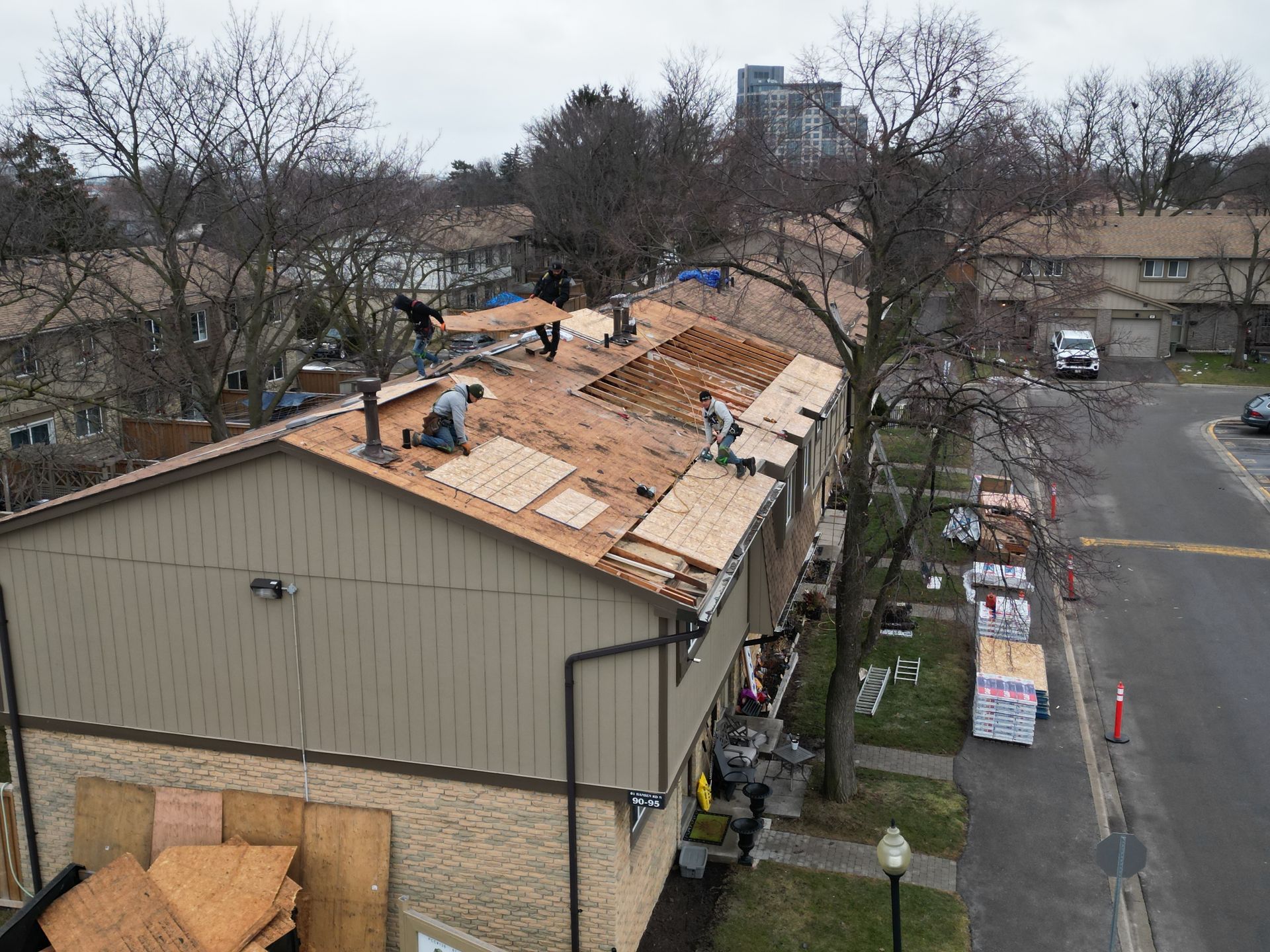 A group of people are working on the roof of a building.