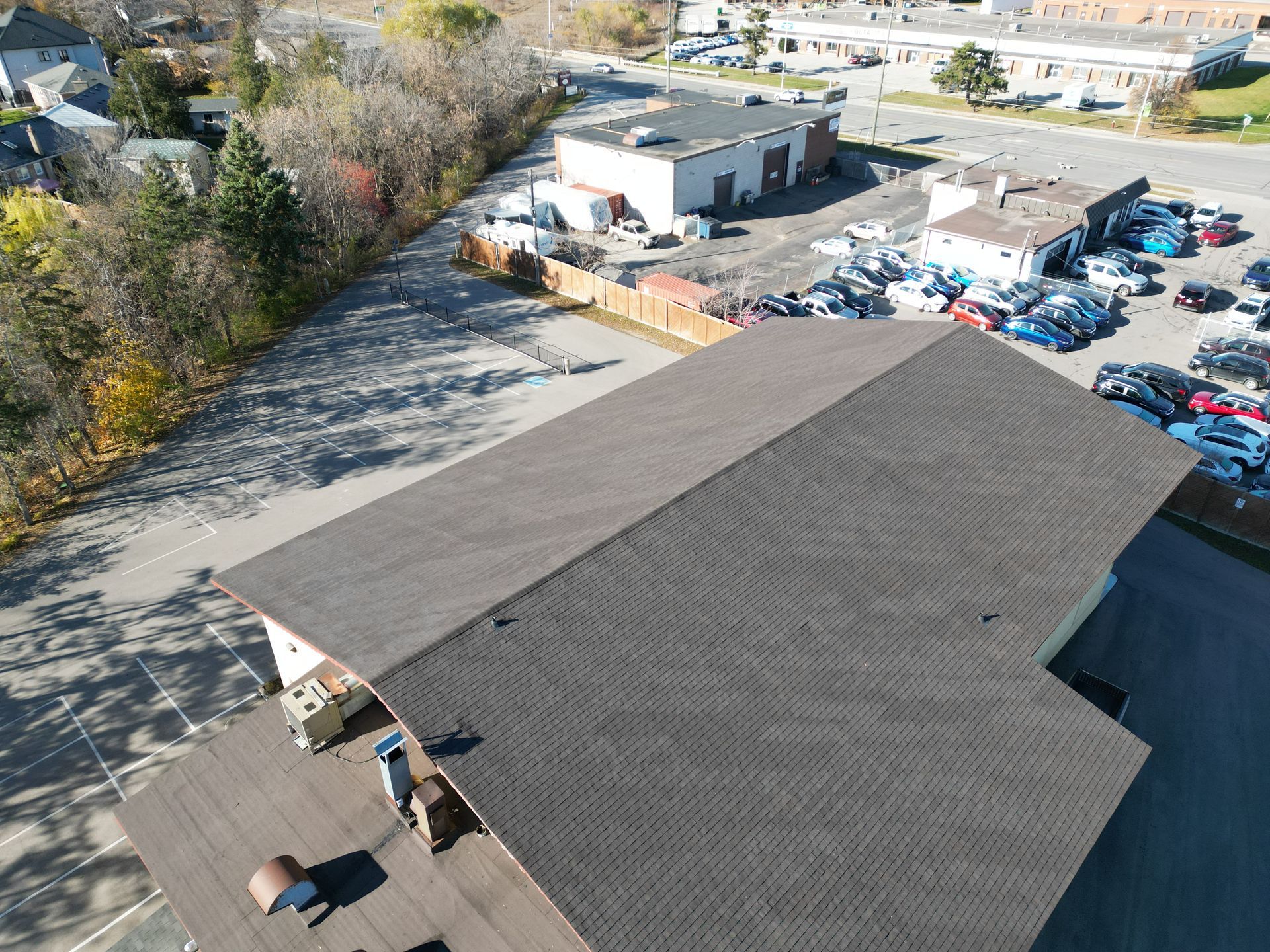An aerial view of a building with a lot of cars parked in front of it.