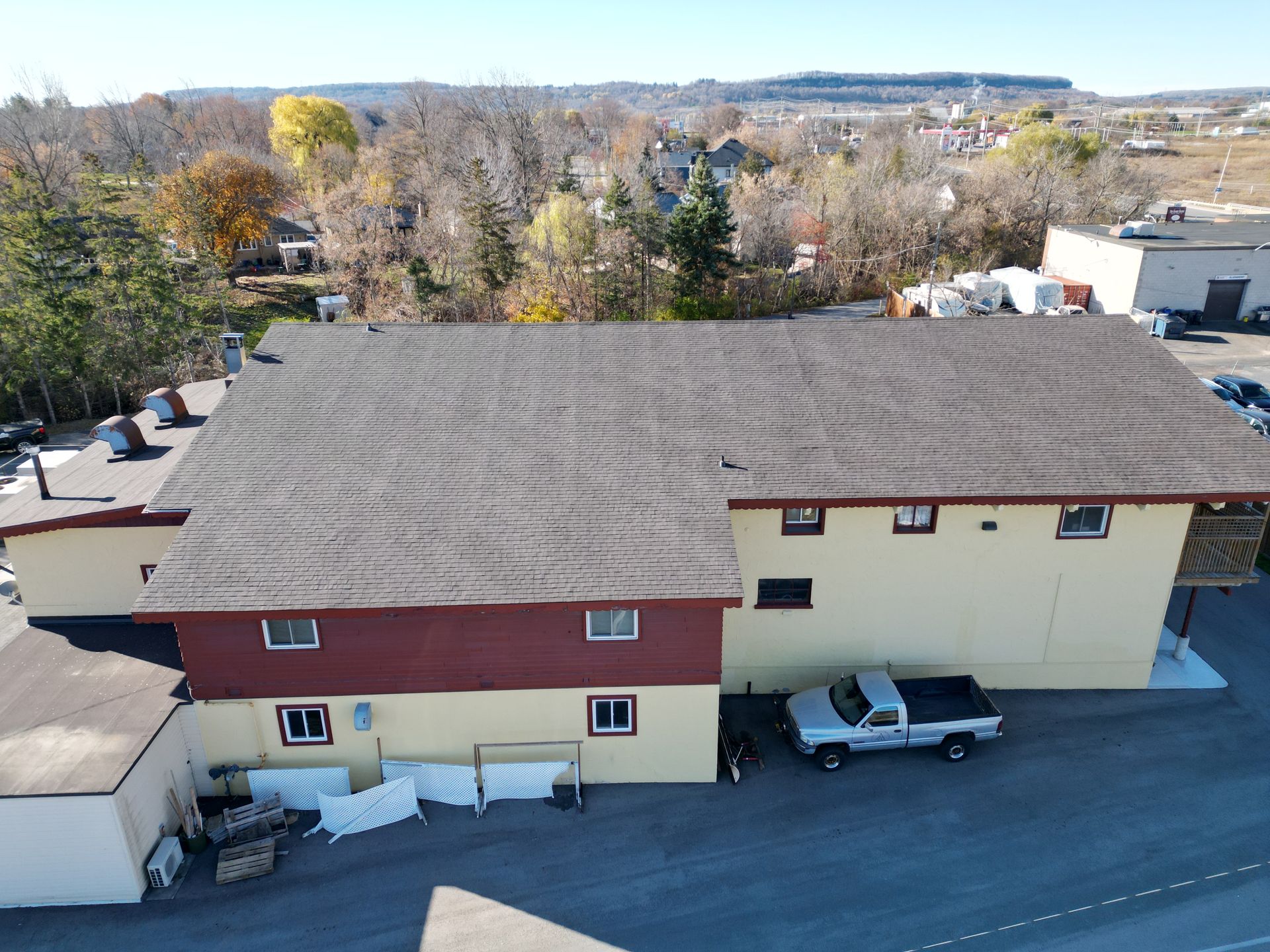 An aerial view of a building with a truck parked in front of it