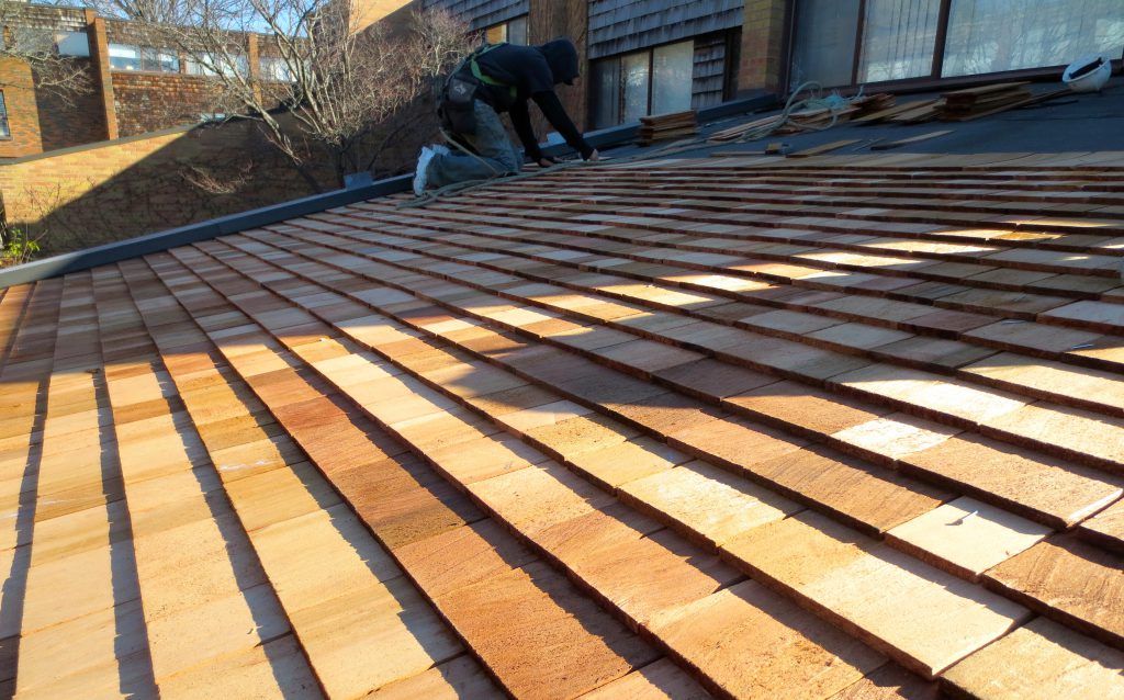A man is working on a wooden roof.