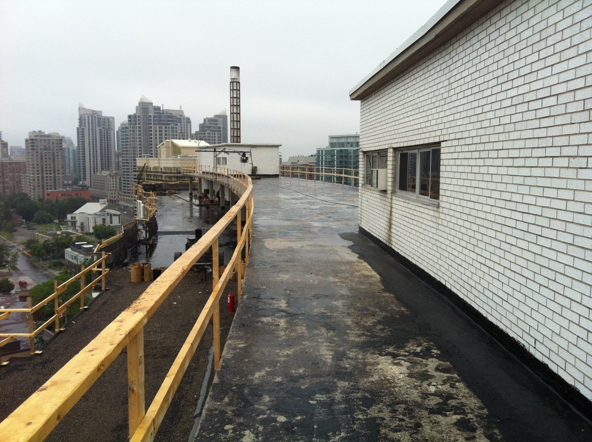 A wooden railing on the roof of a building