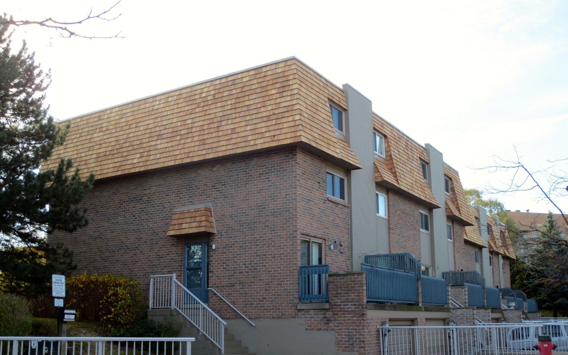 A brick apartment building with a wooden roof