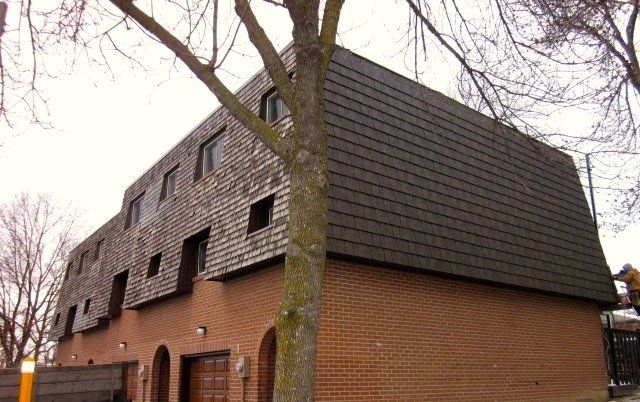 A large brick building with a tree in front of it