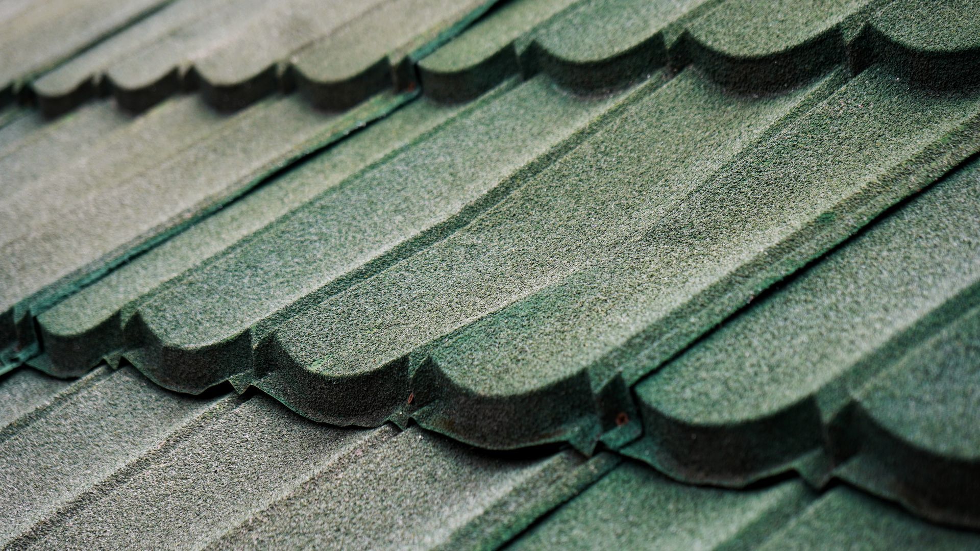 A close up of a green tile roof.