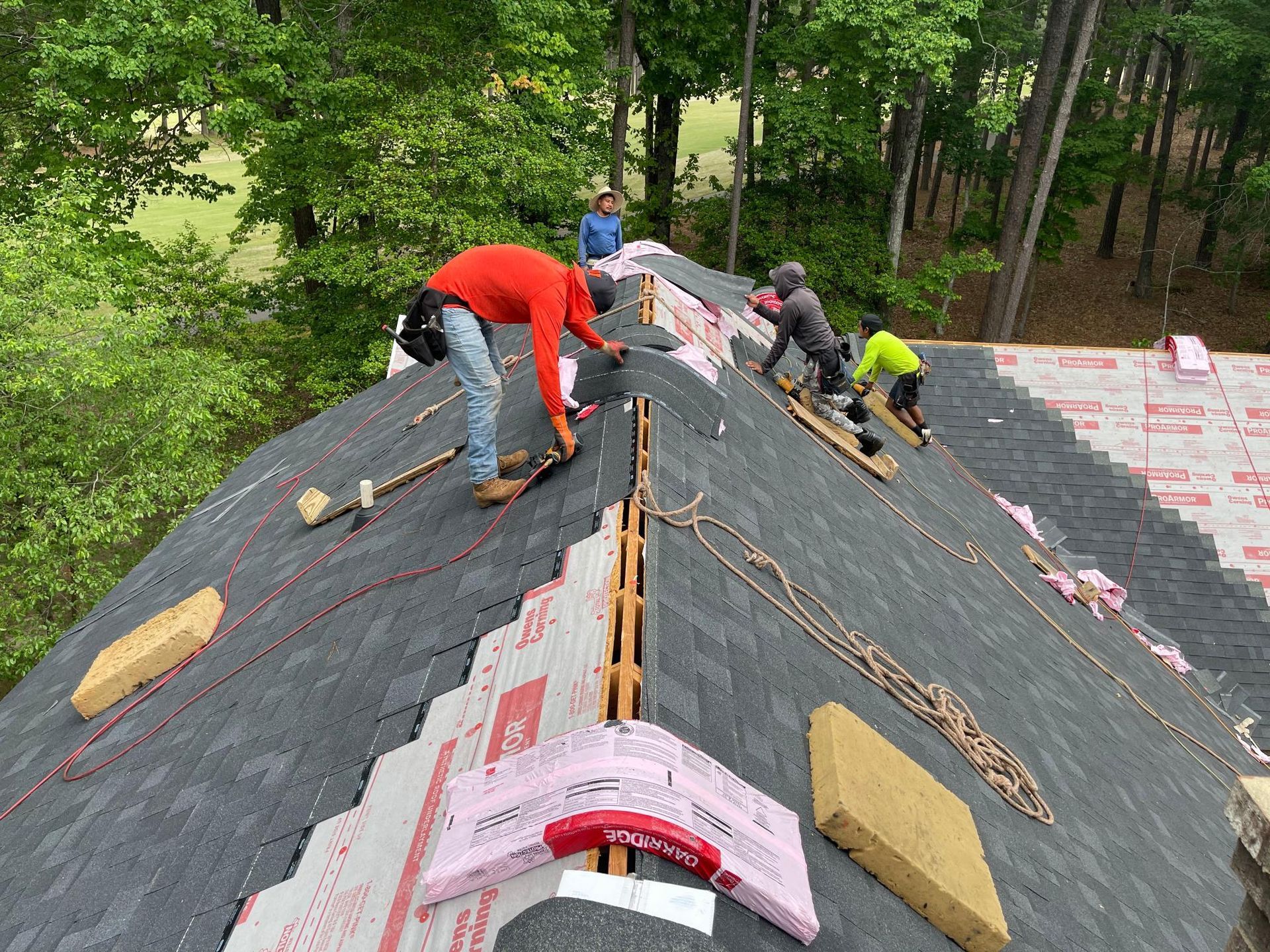 A group of men are working on a roof.