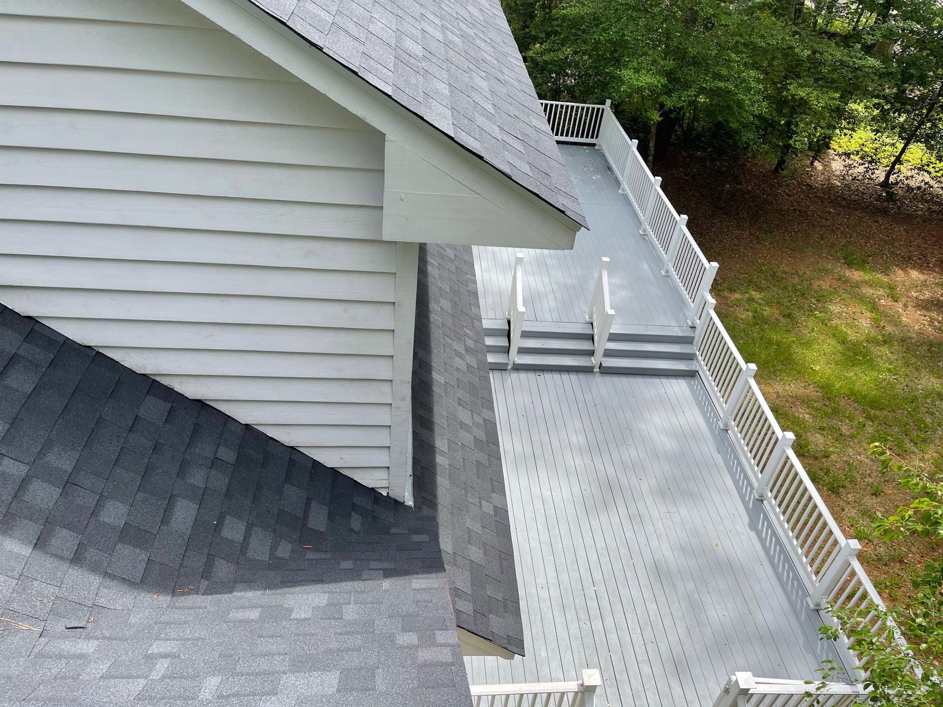 An aerial view of a house with a deck and stairs