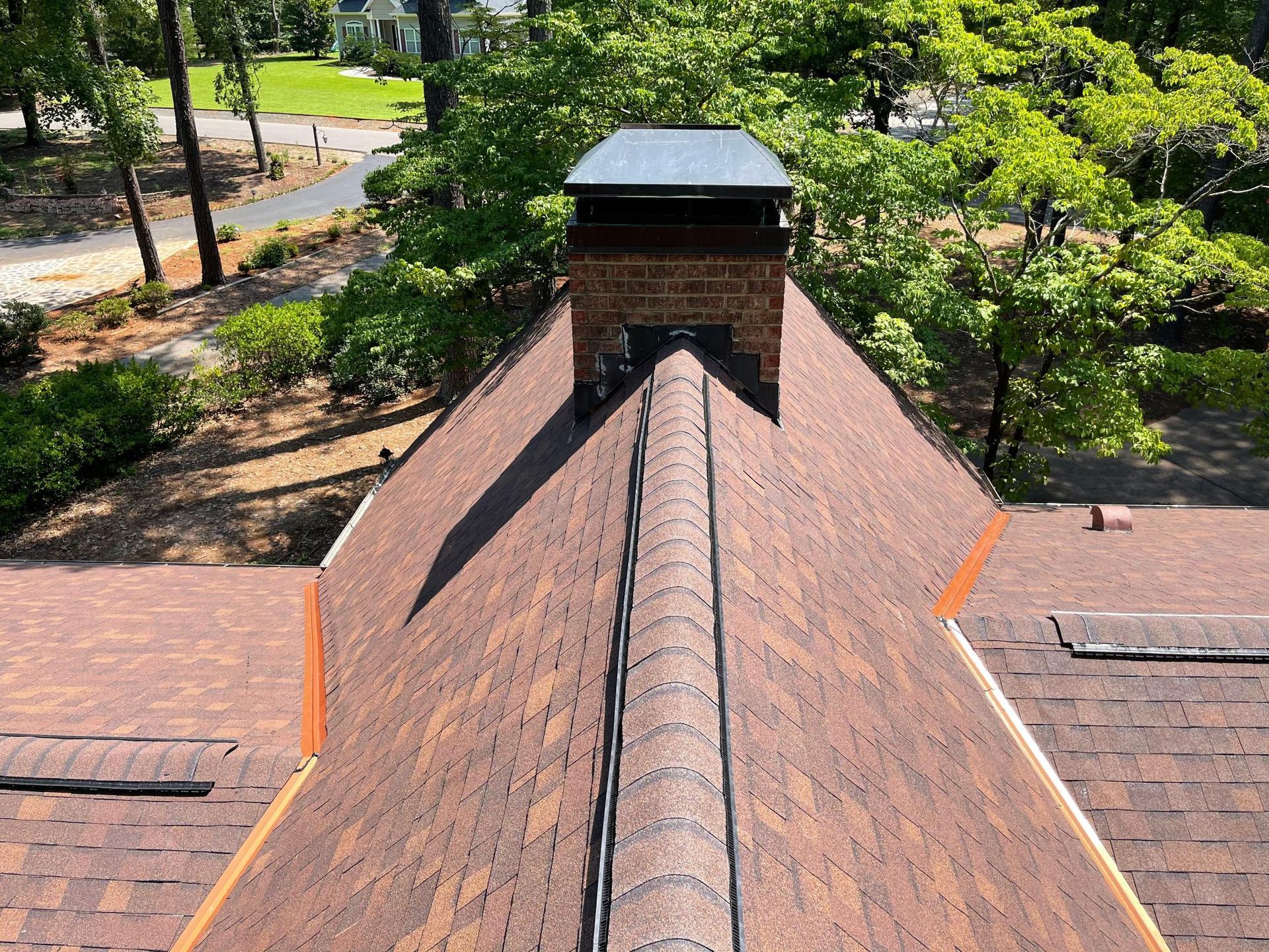 An aerial view of a roof with a chimney on top of it.
