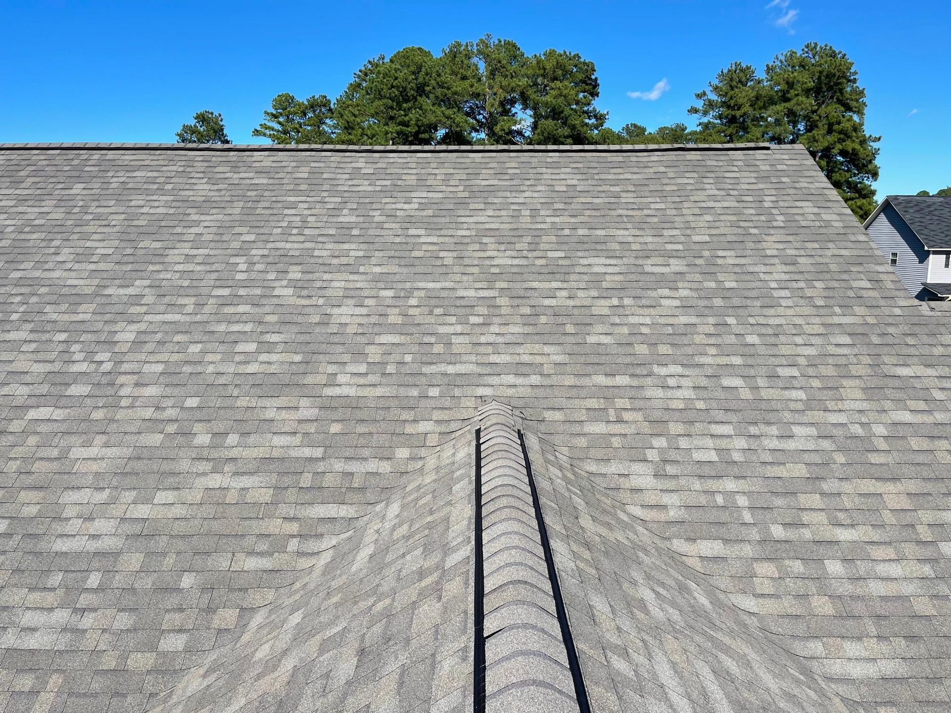 A close up of a roof with a blue sky in the background.