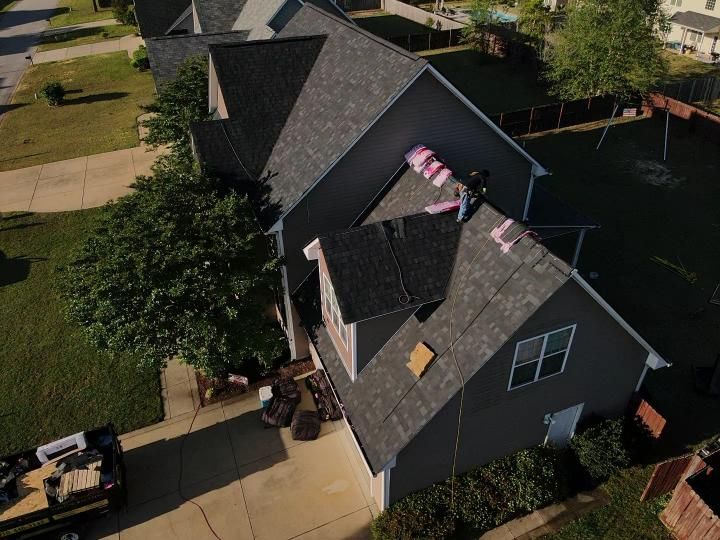 An aerial view of a house with a broken roof