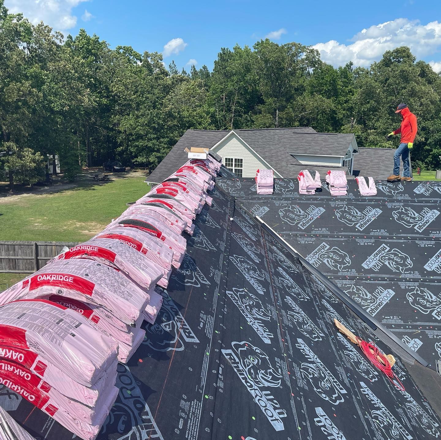 A man is working on the roof of a house