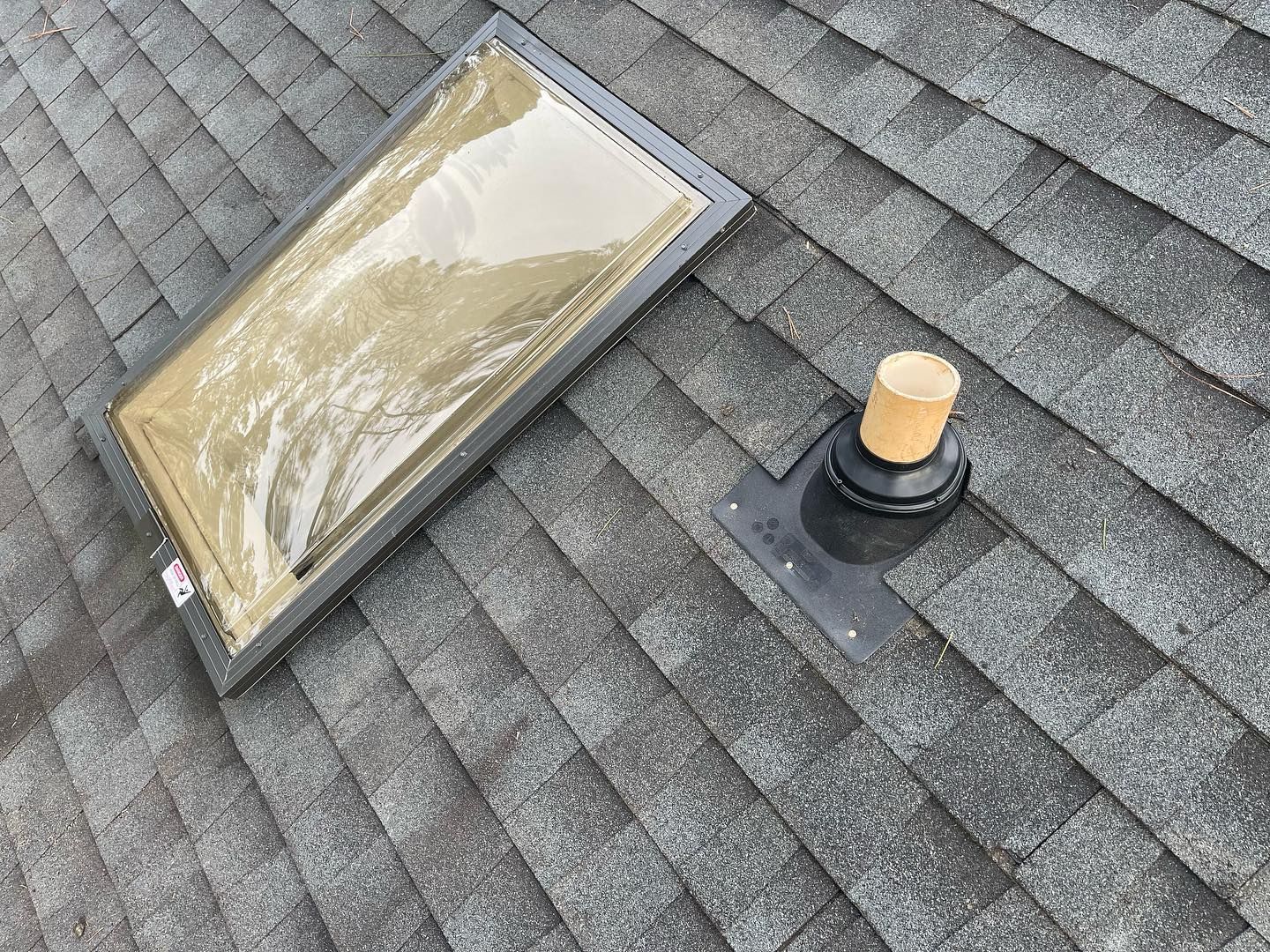 There is a skylight on the roof of a house.