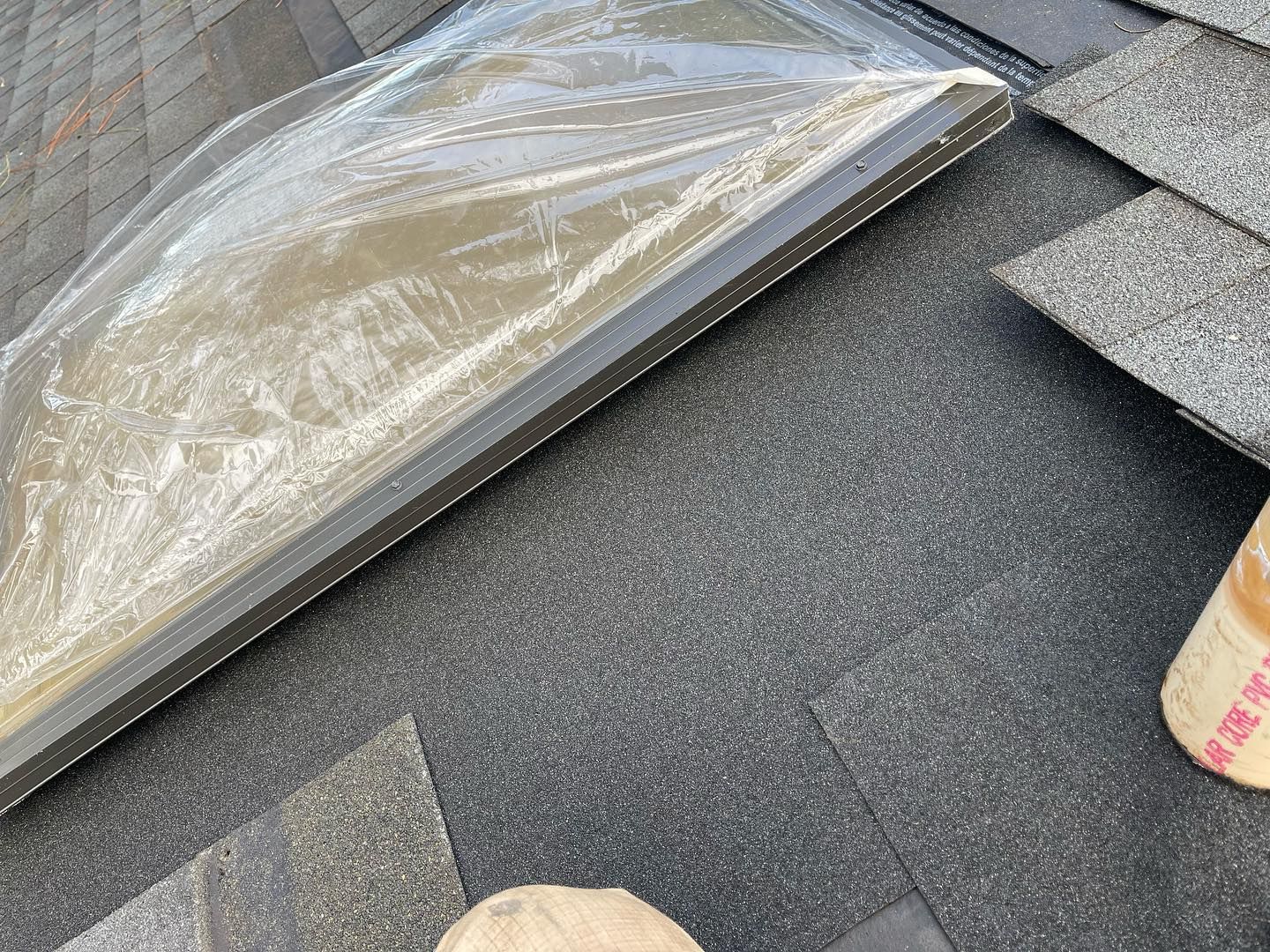 A skylight is being installed on the roof of a house.