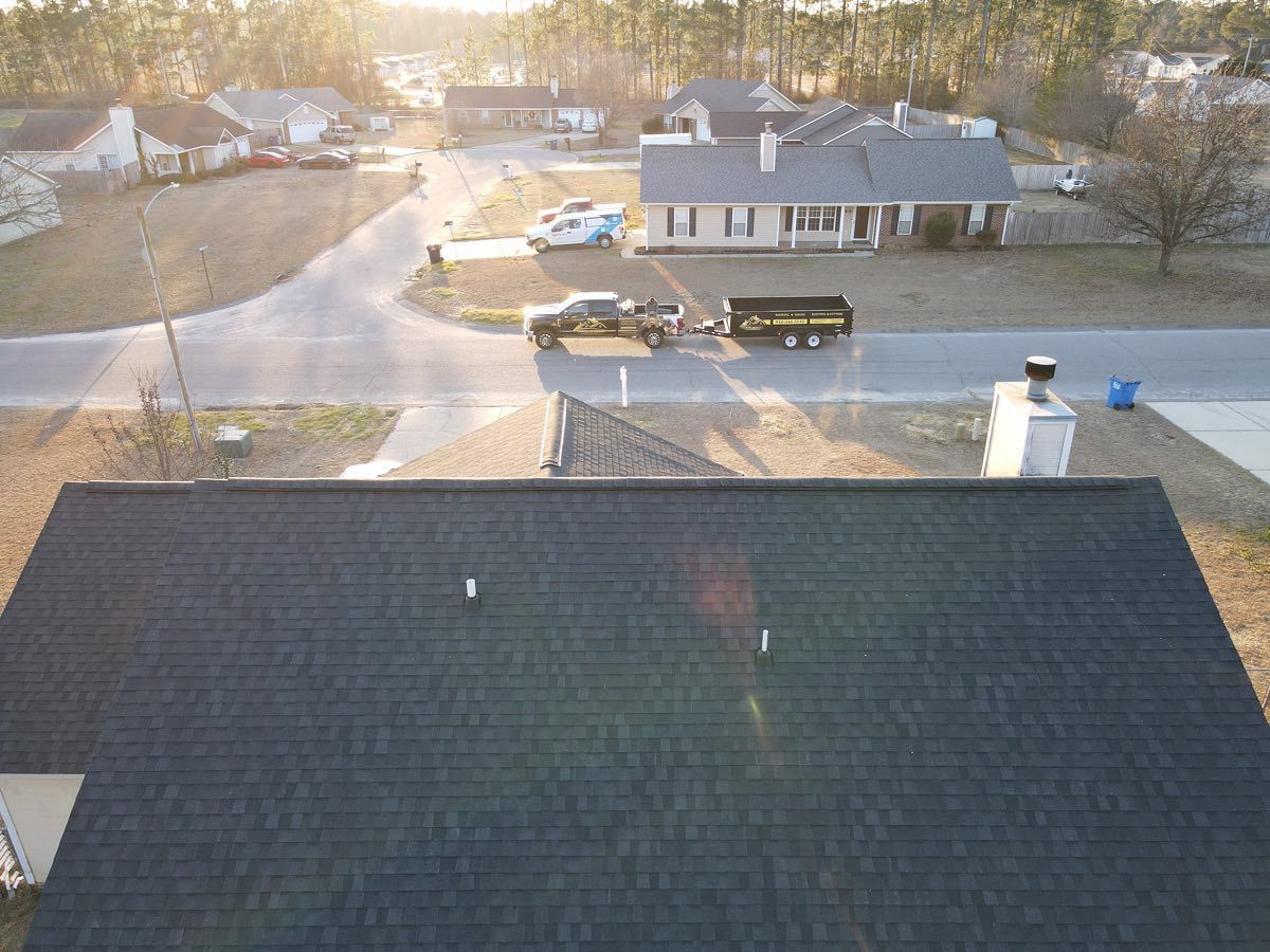 An aerial view of a roof of a house in a residential area.