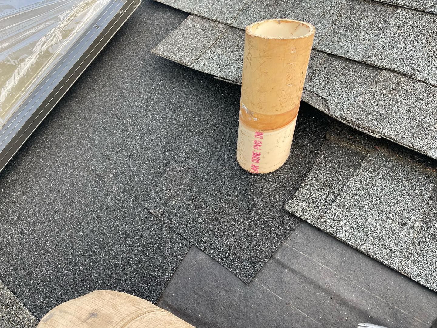 A pipe is sitting on top of a roof.