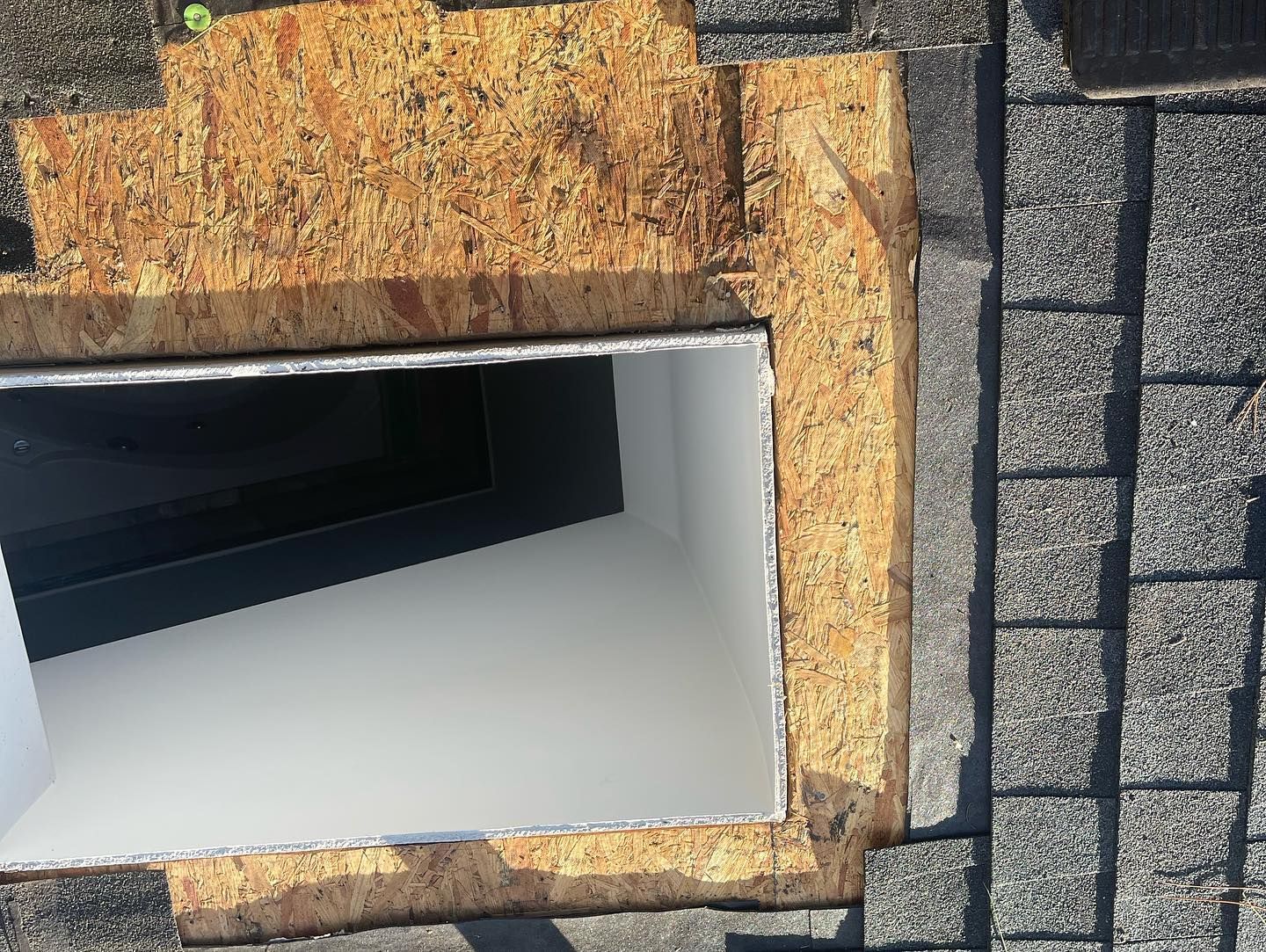 A hole in the ground with a brick wall in the background