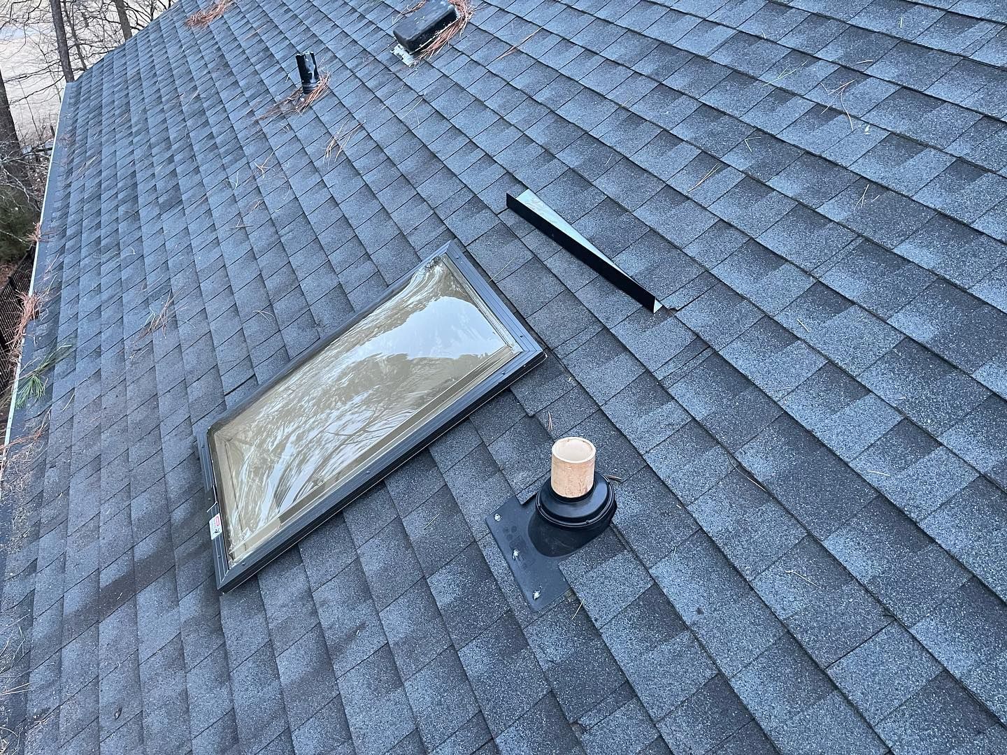 There is a skylight on the roof of a house.