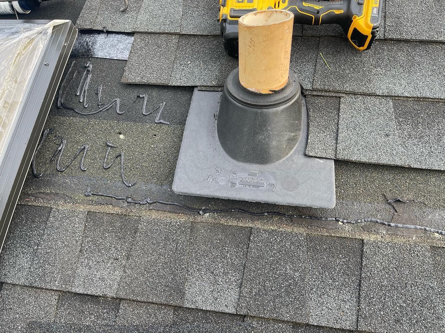 A roof with a hole in it and a drill on it.