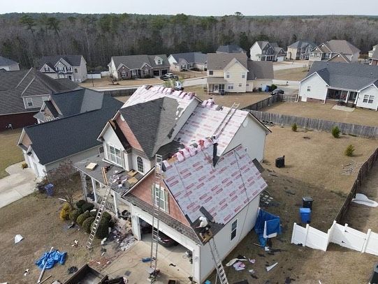 An aerial view of a house being remodeled with a new roof.