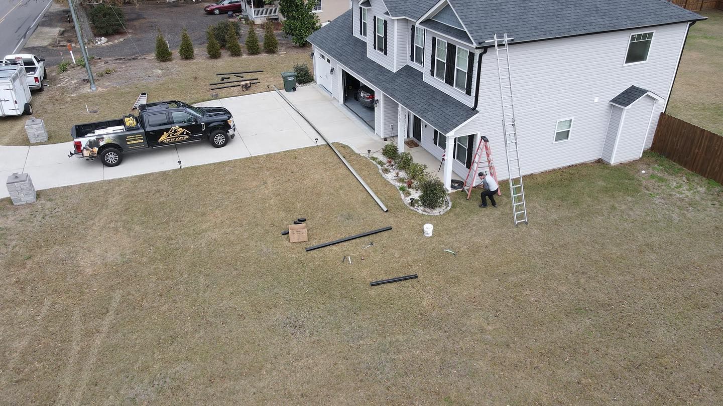 An aerial view of a house with a truck parked in front of it.