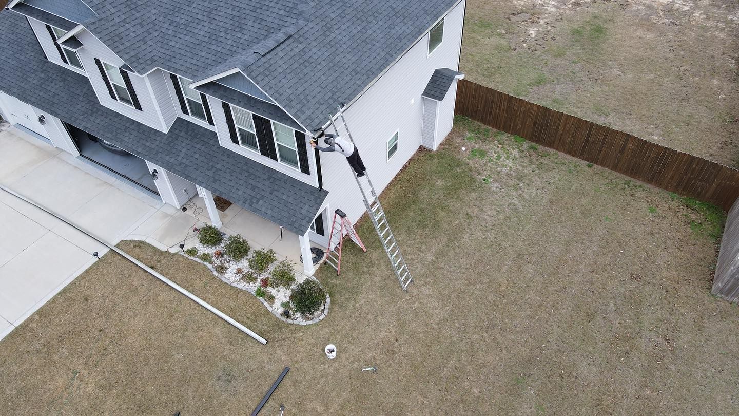 An aerial view of a house with a ladder in front of it.
