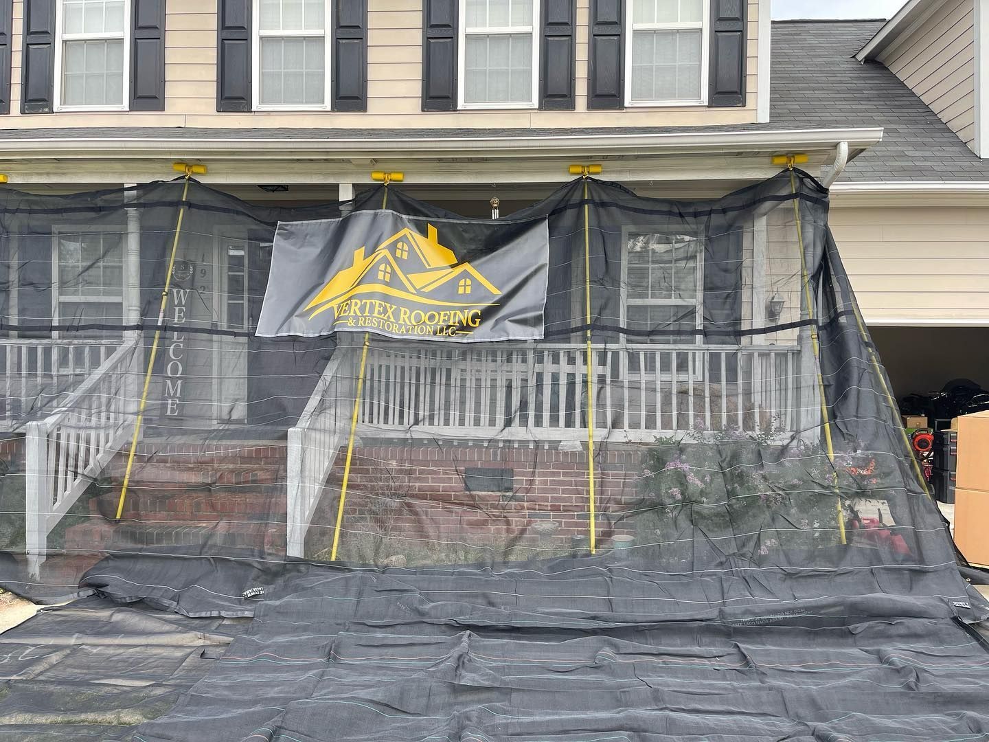 A large black net is covering the front of a house.