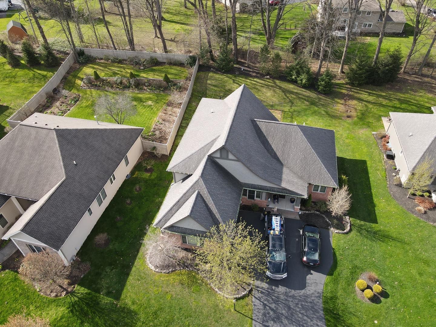 An aerial view of a house with a car parked in front of it.