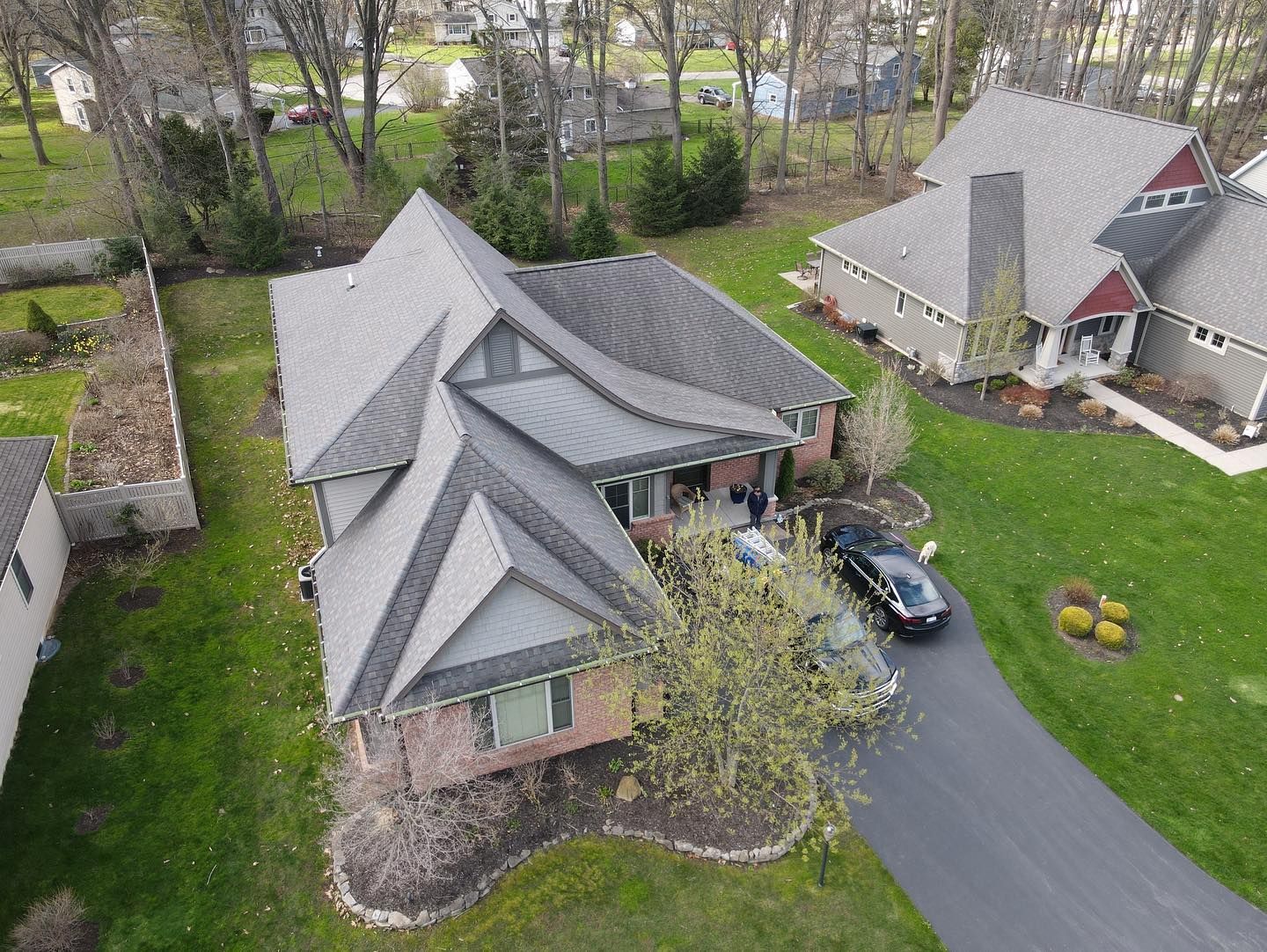 An aerial view of a house with a car parked in front of it.