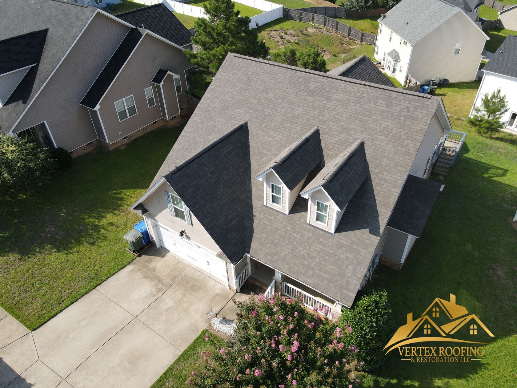 An aerial view of a house with a gray roof