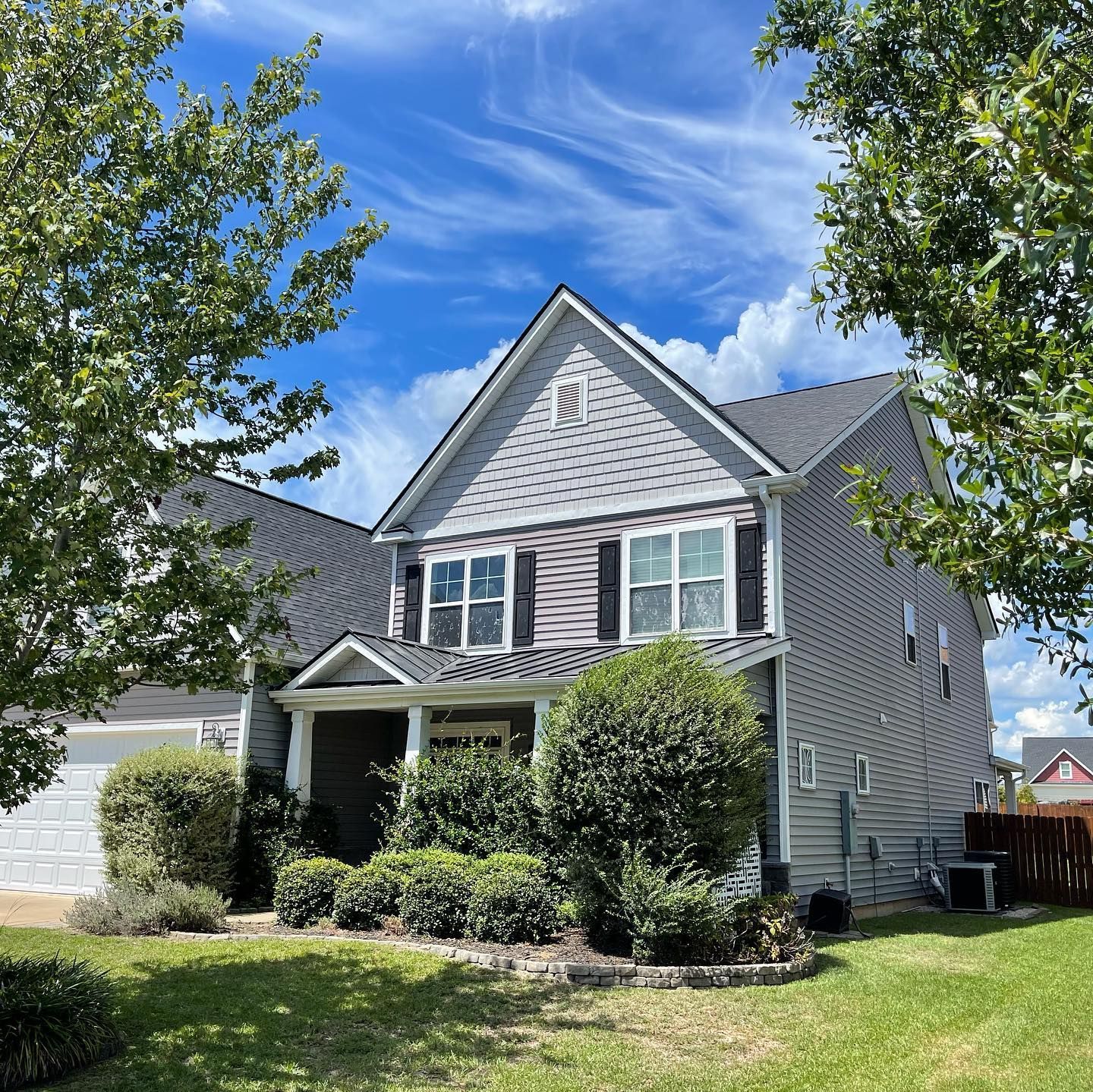 A large house with a lot of windows and trees in front of it