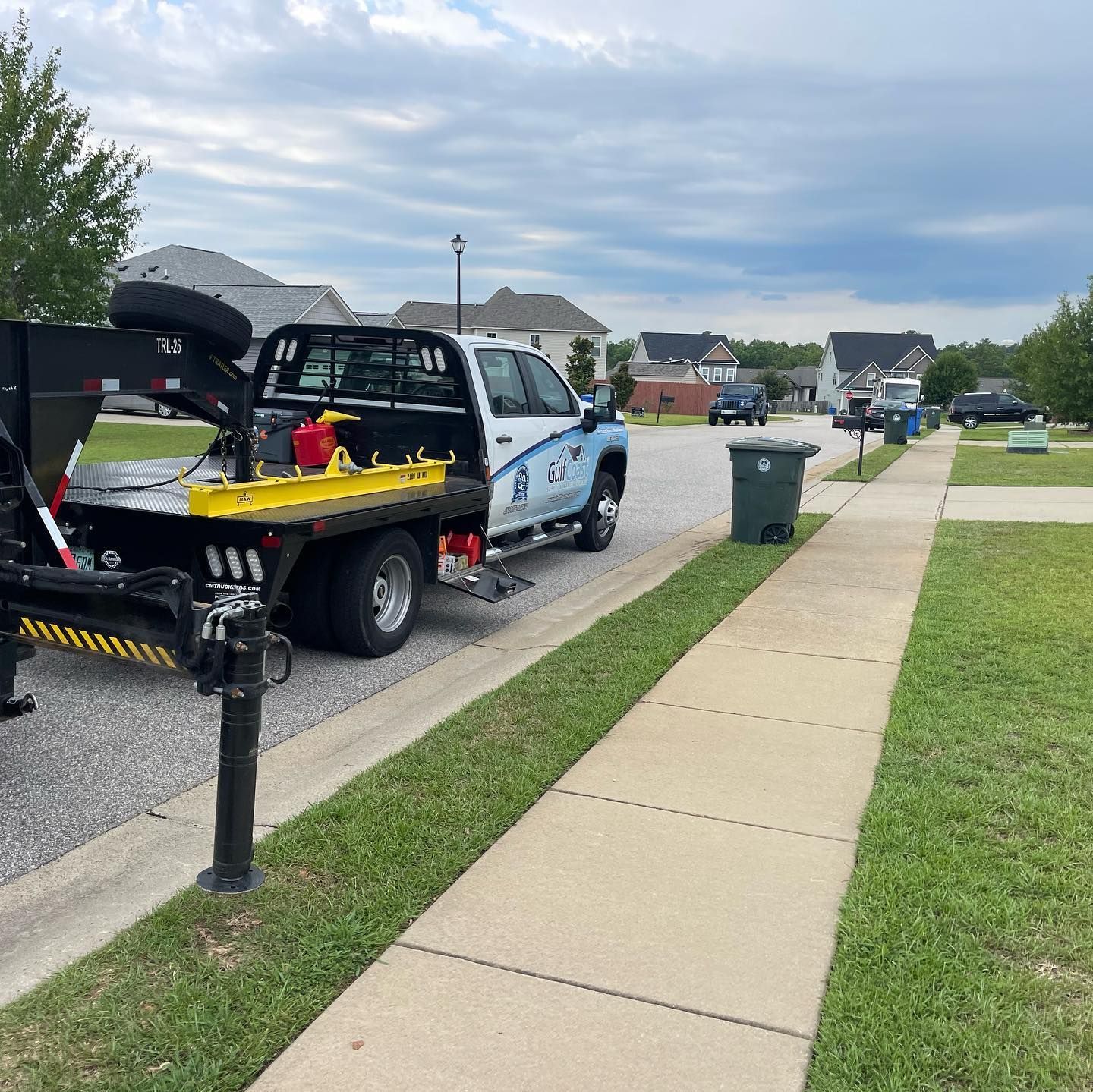 A tow truck is parked on the side of the road