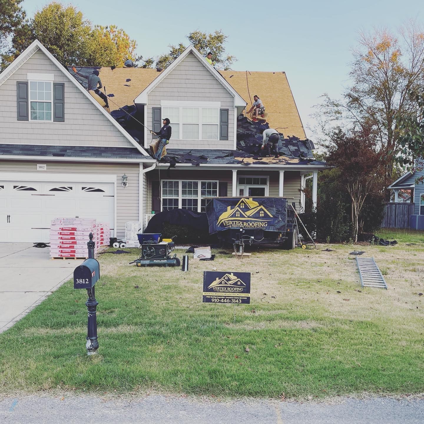 A house that is being remodeled with a sign in front of it