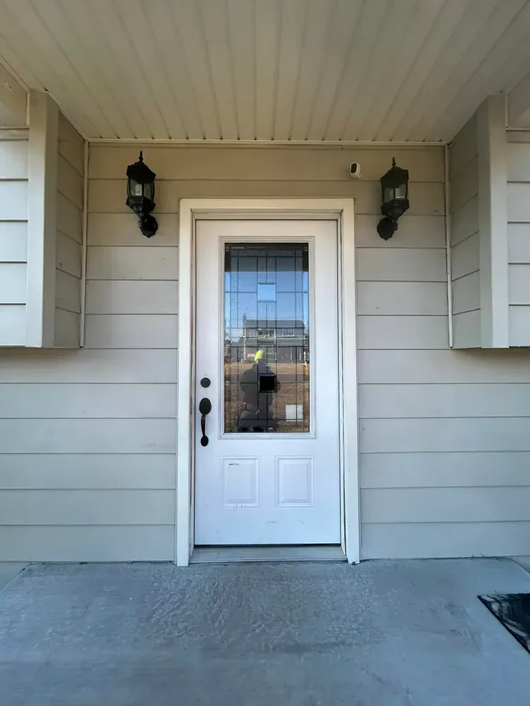 White front door with glass panel.