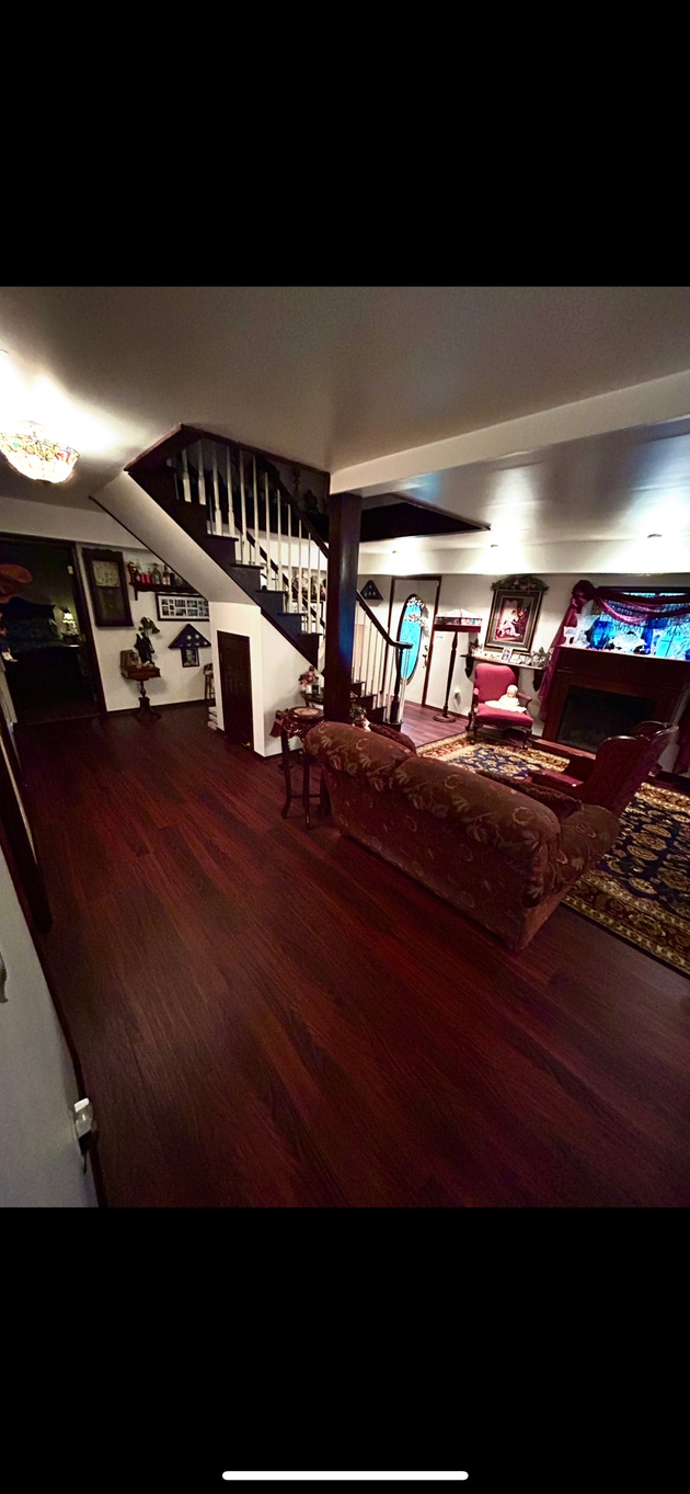 Empty room with unfinished drywall and OSB flooring. Two windows and a door are visible. Empty room with unfinished drywall and OSB flooring. Two windows and a door are visible.