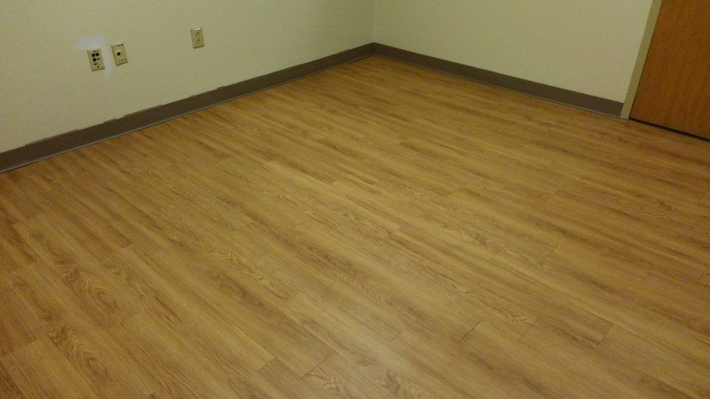 A room with a wooden floor and a door.