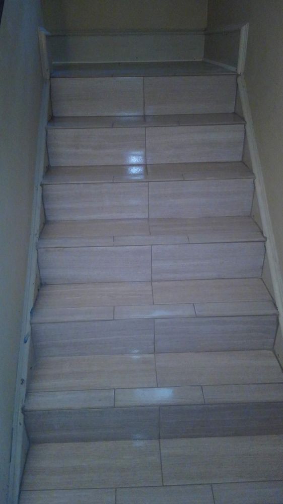 A set of tiled stairs leading up to a second floor.