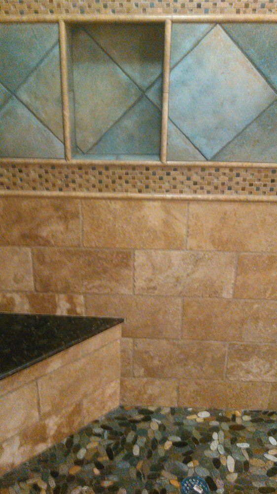 A bathroom with tiled walls and a tiled floor.
