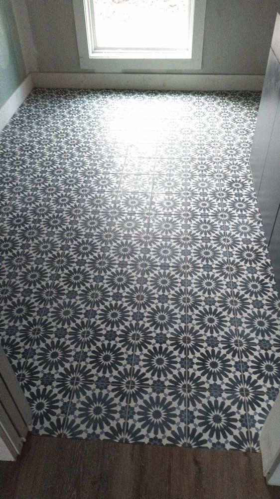 A black and white tile floor with a geometric pattern in a room.