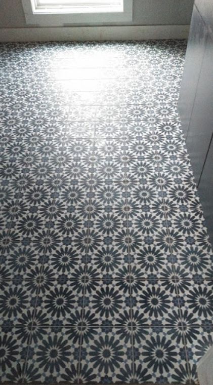A black and white tile floor with a geometric pattern.
