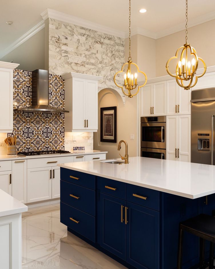 A kitchen with blue cabinets and white counter tops.