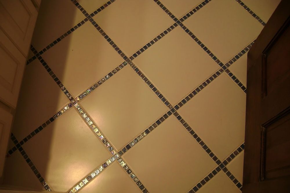 A tiled floor with a diamond pattern and rhinestones.