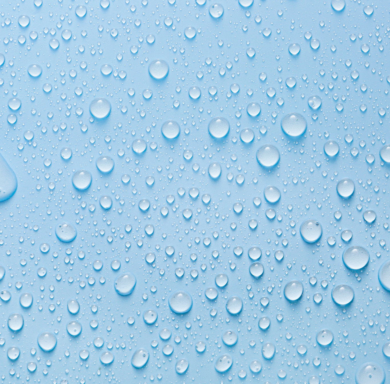 Clear water droplets on a light blue surface, creating a textured pattern.