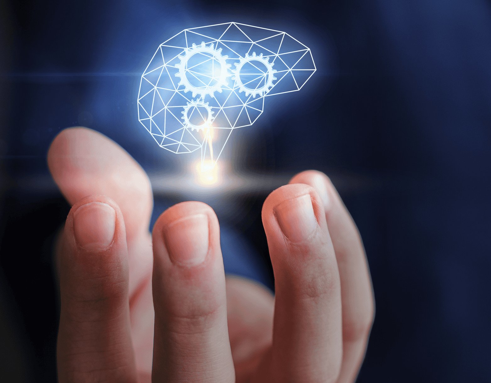 Hand holding a glowing brain with gears, symbolizing intelligence and innovation.
