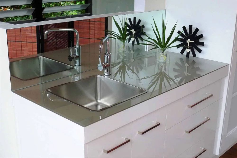 A Kitchen Counter With A Sink And A Mirror — Hayes & Swinburn Glass in Westcourt, QLD