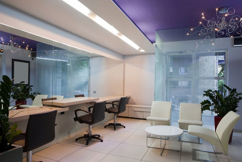 A Salon With A Purple Ceiling And White Chairs — Hayes & Swinburn Glass in Westcourt, QLD