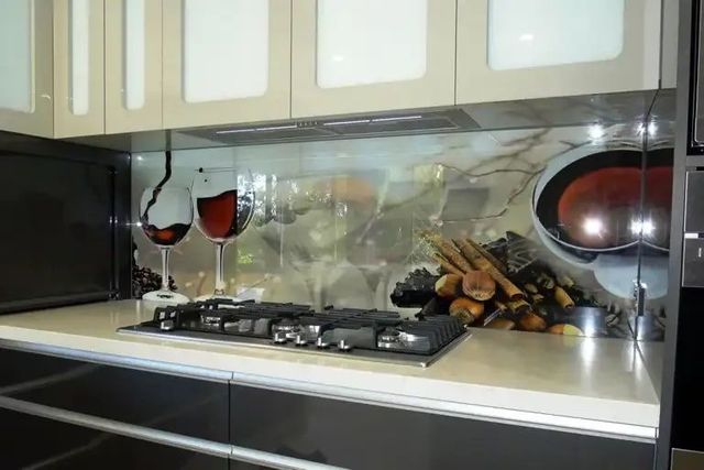 A Kitchen With a Stove Top Oven and a Glass of Wine on the Counter — Hayes & Swinburn Glass in Westcourt, QLD