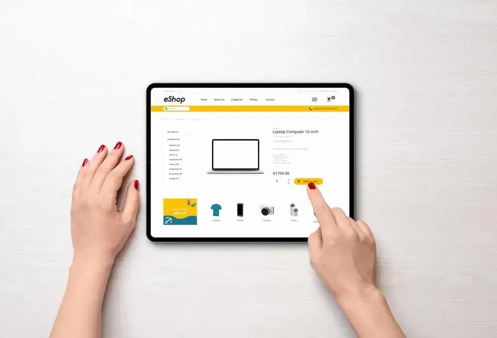 A woman is using a tablet computer to shop online.