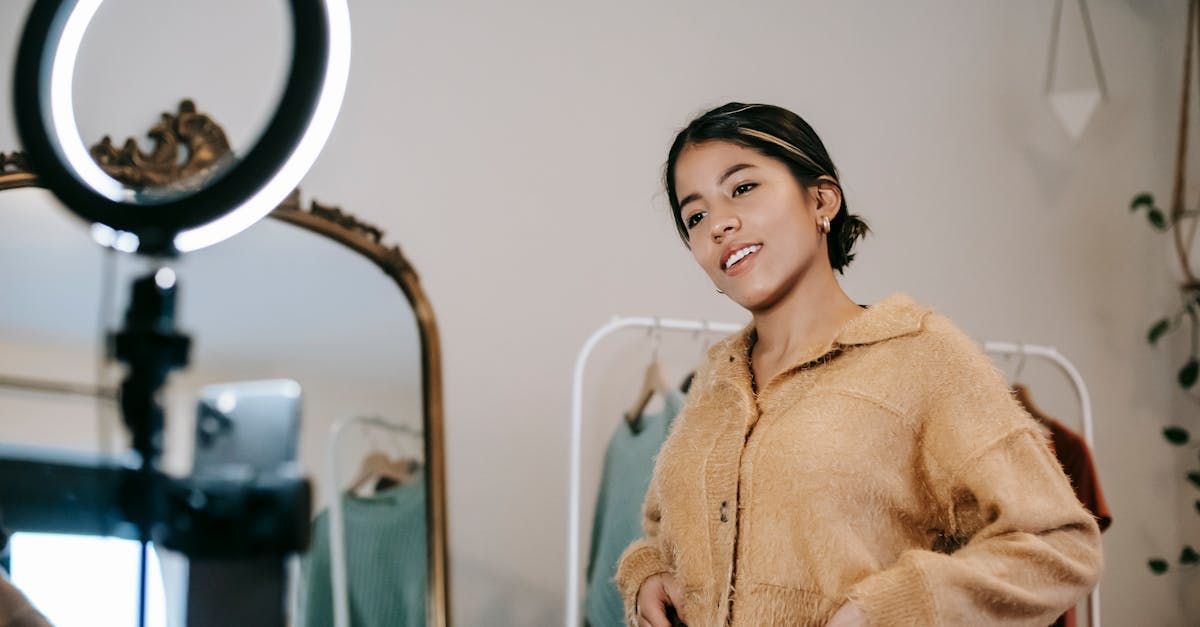 A woman is taking a picture of herself in front of a mirror with a ring light.