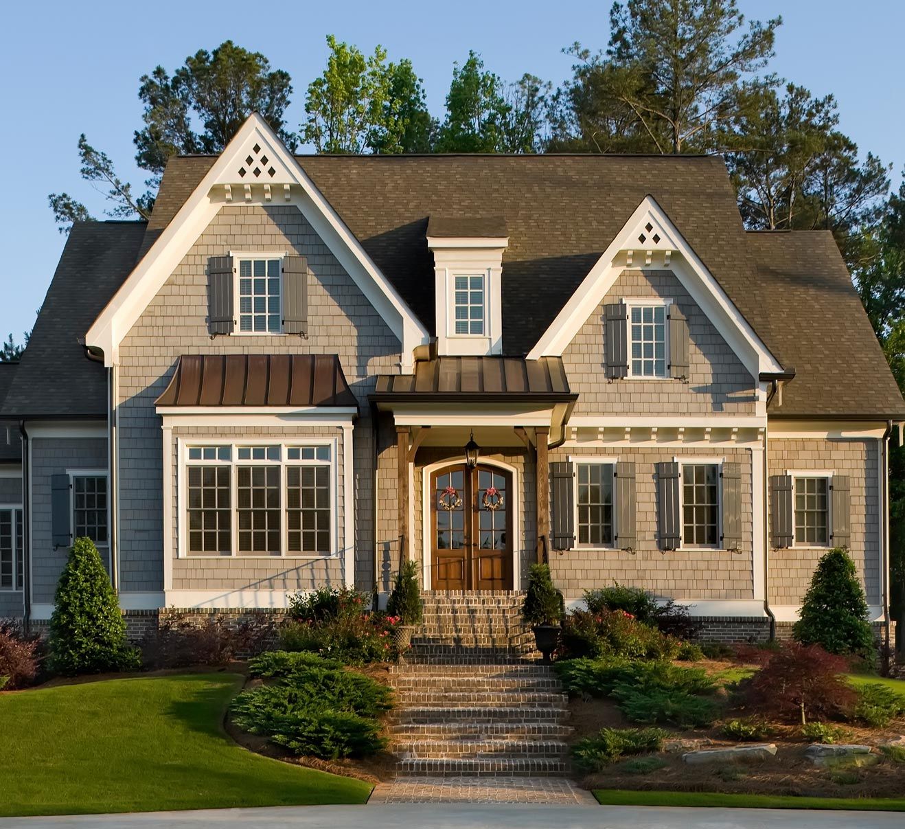 A large house with stairs leading up to the front door