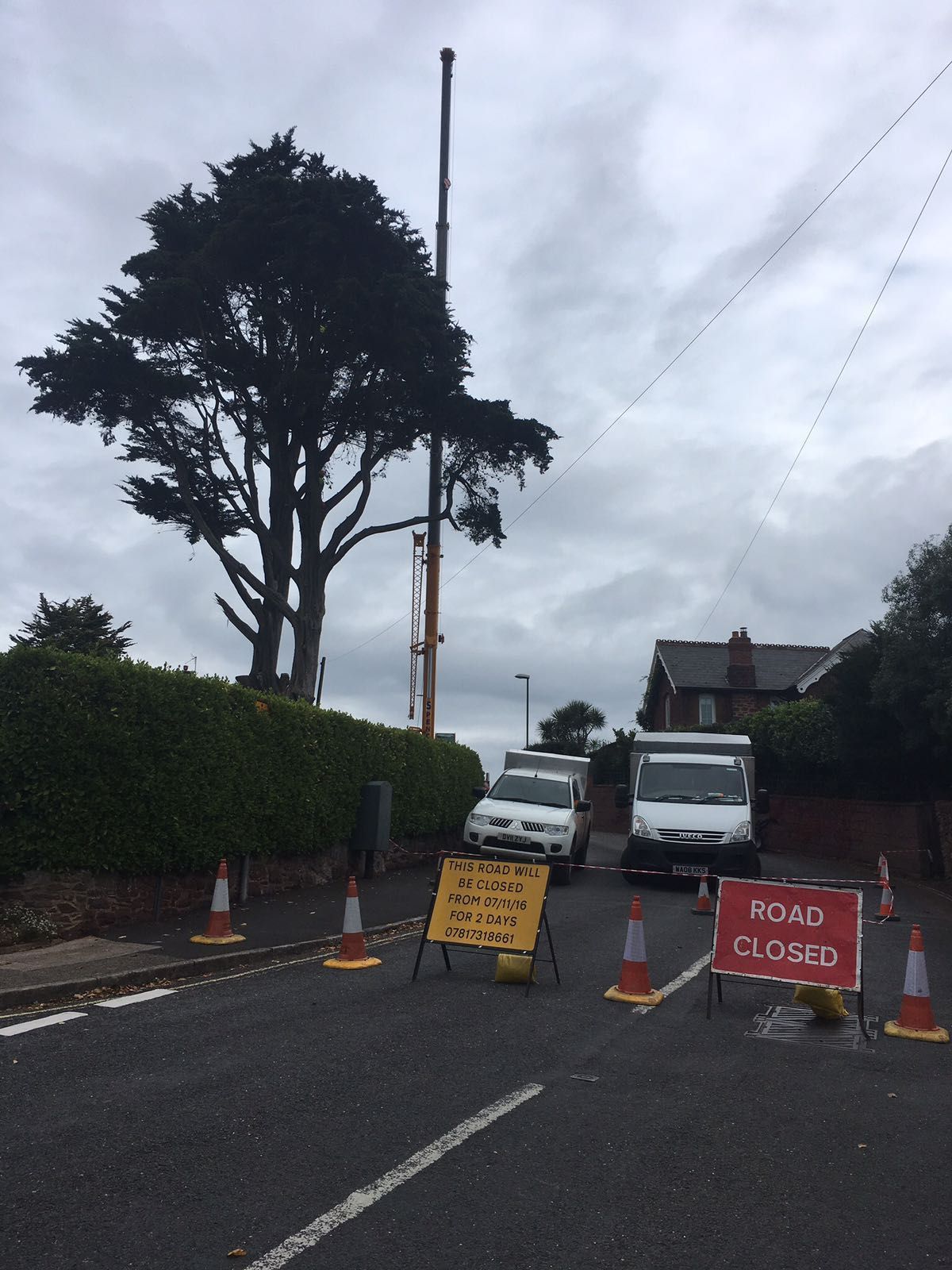 A road closed sign is on the side of the road