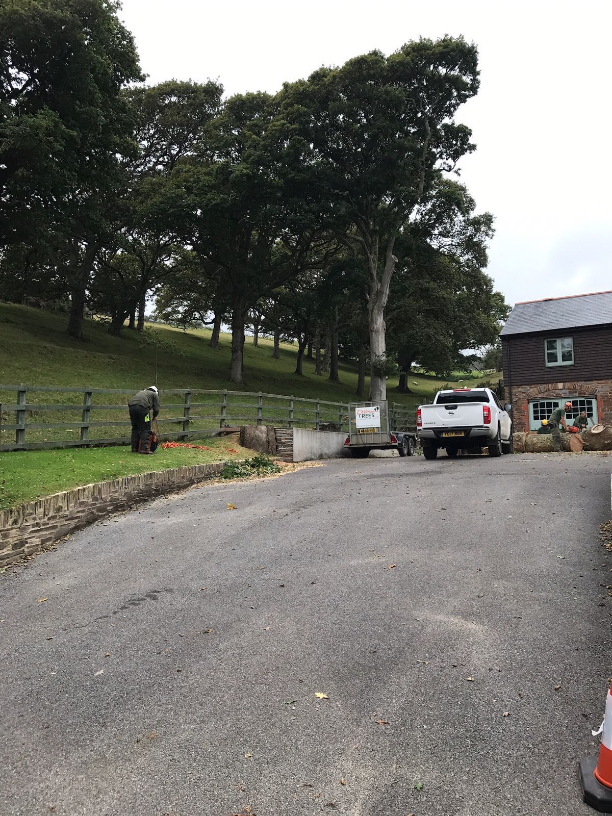 A white truck is parked on the side of the road in front of a house.